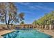 Community pool with lounge chairs and trees at 1342 W Emerald Ave # 344, Mesa, AZ 85202