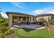 Covered patio, putting green, and grassy area at 13442 W Blackstone Ln, Peoria, AZ 85383