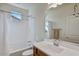 Clean bathroom featuring a bathtub, double vanity, and window at 13442 W Blackstone Ln, Peoria, AZ 85383