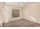 Comfortable bedroom with neutral carpet, bright light and ceiling fan at 14575 W Mountain View Blvd # 11222, Surprise, AZ 85374