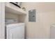 Functional laundry room with a white washer, dryer, and storage shelves at 14575 W Mountain View Blvd # 11222, Surprise, AZ 85374