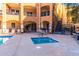 Community pool area featuring a spa and lounge chairs at 14575 W Mountain View Blvd # 11222, Surprise, AZ 85374