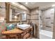 Bathroom featuring decorative vanity, large mirror, and tiled shower-tub combo at 14615 N 28Th St, Phoenix, AZ 85032