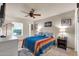 Bedroom featuring tile flooring, ceiling fan, double hung windows, and comfortable bedding at 14615 N 28Th St, Phoenix, AZ 85032