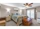 Cozy bedroom featuring a ceiling fan, carpet flooring, and backyard access at 14615 N 28Th St, Phoenix, AZ 85032