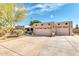 Spacious home exterior featuring a wide driveway leading to a two-car garage, complemented by desert landscaping at 14615 N 28Th St, Phoenix, AZ 85032