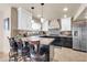 Well-lit kitchen featuring stainless steel appliances, breakfast bar, and tile backsplash at 14615 N 28Th St, Phoenix, AZ 85032