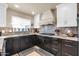 Well-equipped kitchen with dark cabinetry, ample counter space, and modern appliances for culinary enthusiasts at 14615 N 28Th St, Phoenix, AZ 85032