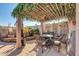 Charming patio area with vine-covered pergola, seating, and decorative accents for outdoor enjoyment at 14615 N 28Th St, Phoenix, AZ 85032