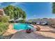 Serene backyard pool area with comfortable lounge seating and mature trees at 14615 N 28Th St, Phoenix, AZ 85032