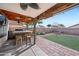 Outdoor kitchen and patio with artificial turf and bar seating at 14885 W Caribbean Ln, Surprise, AZ 85379