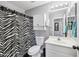 Clean bathroom with white vanity and zebra-print shower curtain at 14885 W Caribbean Ln, Surprise, AZ 85379