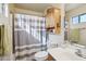 Bathroom with a shower/tub combo and wood cabinet at 14885 W Caribbean Ln, Surprise, AZ 85379