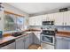 Modern kitchen with stainless steel appliances and gray cabinets at 14885 W Caribbean Ln, Surprise, AZ 85379