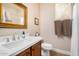 Half bathroom features a wood vanity, tiled floors, and white counter top at 15240 N 142Nd Ave # 1149, Surprise, AZ 85379