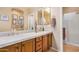 Bathroom featuring dual sinks, framed mirrors, and a shower at 15240 N 142Nd Ave # 1149, Surprise, AZ 85379