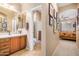 Bathroom featuring dual sinks, framed mirrors, and tiled floors at 15240 N 142Nd Ave # 1149, Surprise, AZ 85379