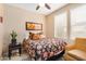 Well-lit bedroom featuring a large window, side table, and sitting chair at 15240 N 142Nd Ave # 1149, Surprise, AZ 85379