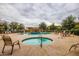 Community pool and spa featuring a covered seating area, table seating and desert landscaping at 15240 N 142Nd Ave # 1149, Surprise, AZ 85379