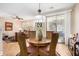 Dining area with a stylish light fixture, tiled floor, and a sliding door to the outside at 15240 N 142Nd Ave # 1149, Surprise, AZ 85379