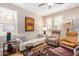 Bright living room featuring a white sofa, two armchairs, and tile floors at 15240 N 142Nd Ave # 1149, Surprise, AZ 85379