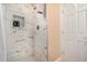 This shower stall features neutral tile and a built-in soap niche at 15240 N 142Nd Ave # 1149, Surprise, AZ 85379