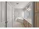 Bright bathroom featuring a soaking tub, walk-in shower, dual sinks and tile flooring at 15704 W Sentinel Dr, Sun City West, AZ 85375