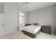 Comfortable bedroom showcasing neutral decor, a ceiling fan, and an ensuite bathroom, promoting relaxation at 15704 W Sentinel Dr, Sun City West, AZ 85375