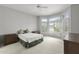 A cozy bedroom featuring neutral tones, a ceiling fan, and shuttered windows, providing a peaceful retreat at 15704 W Sentinel Dr, Sun City West, AZ 85375