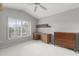 Bedroom with vaulted ceiling, ceiling fan, shuttered window, and built-in desk at 15704 W Sentinel Dr, Sun City West, AZ 85375