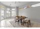 Dining area features a modern table setting, natural light, and views to exterior of home at 15704 W Sentinel Dr, Sun City West, AZ 85375