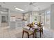 Dining area connecting to the open kitchen, with a table set for a meal, bathed in natural light at 15704 W Sentinel Dr, Sun City West, AZ 85375