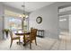 Dining area with a charming chandelier, table set for tea, and view of the outdoor patio at 15704 W Sentinel Dr, Sun City West, AZ 85375