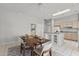 Open dining area with a table set for four, connecting seamlessly to the kitchen area and bright interiors at 15704 W Sentinel Dr, Sun City West, AZ 85375