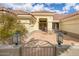 Inviting front yard featuring a tile patio and charming gate with meticulously maintained landscaping at 15704 W Sentinel Dr, Sun City West, AZ 85375