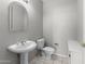 Modern half bathroom featuring a pedestal sink and tiled flooring at 15704 W Sentinel Dr, Sun City West, AZ 85375