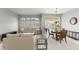 Stylish living room and dining area featuring plantation shutters and patio access at 15704 W Sentinel Dr, Sun City West, AZ 85375