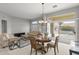 Bright living room featuring a cozy seating area and sliding glass doors to the patio at 15704 W Sentinel Dr, Sun City West, AZ 85375