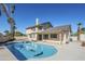 Spacious backyard features a large pool with dolphin art, and a covered patio at 15857 N 51St Pl, Scottsdale, AZ 85254