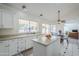 Bright kitchen featuring white cabinetry, a center island, and a view of the connected Gathering room at 15857 N 51St Pl, Scottsdale, AZ 85254