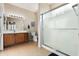 Bright bathroom featuring a glass-enclosed shower and ample counter space at 17061 W Peregrine Ln, Surprise, AZ 85387