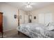 Relaxing bedroom with a four-poster bed, ceiling fan, and a view through the door at 17061 W Peregrine Ln, Surprise, AZ 85387