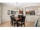 Charming dining area adjacent to the kitchen with a stylish chandelier and comfortable seating at 17061 W Peregrine Ln, Surprise, AZ 85387