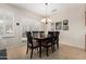 Cozy dining area with a dark wood table, neutral walls, and natural light from the window at 17061 W Peregrine Ln, Surprise, AZ 85387