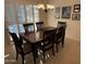 Dining room with a wood table, six chairs, and a chandelier at 17061 W Peregrine Ln, Surprise, AZ 85387