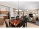 Open dining area flowing into the living room and kitchen, perfect for entertaining and gatherings at 17061 W Peregrine Ln, Surprise, AZ 85387