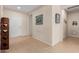 Foyer featuring tile flooring, neutral walls, and decorative wall art at 17061 W Peregrine Ln, Surprise, AZ 85387