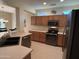 Kitchen with wood cabinets, stainless steel appliances, and a large island at 17061 W Peregrine Ln, Surprise, AZ 85387