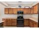 Well-lit kitchen featuring ample cabinetry and countertops for cooking and storage at 17061 W Peregrine Ln, Surprise, AZ 85387