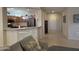 Living room with a gray couch and view of kitchen and entryway at 17061 W Peregrine Ln, Surprise, AZ 85387